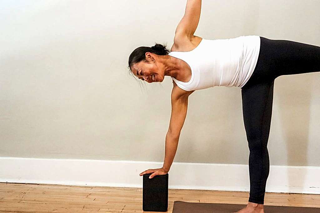 teacher balancing on yoga block